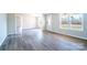 Living room featuring gray vinyl floors and neutral walls with a front door and windows at 3416 Polkville Rd, Shelby, NC 28150