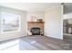 Bright living room featuring a stone fireplace, hardwood floors, and neutral wall colors at 3416 Polkville Rd, Shelby, NC 28150