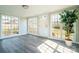 Bright sunroom featuring large windows, modern flooring, and a rear door entrance at 3416 Polkville Rd, Shelby, NC 28150