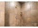 Walk-in shower with tile surround and a built-in shelf at 3572 Artists Way, Charlotte, NC 28205