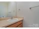 Simple, clean bathroom with wood vanity and a mirror at 3649 Warp St, Charlotte, NC 28205