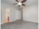 Bright bedroom with grey carpet, ceiling fan and ensuite bathroom at 3649 Warp St, Charlotte, NC 28205