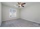 Bright bedroom with ceiling fan and grey carpeting at 3649 Warp St, Charlotte, NC 28205