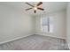 Well-lit bedroom featuring ceiling fan and grey carpet at 3649 Warp St, Charlotte, NC 28205