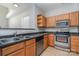 Kitchen with wood cabinets, stainless steel appliances, and a double sink at 3649 Warp St, Charlotte, NC 28205