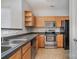 Galley kitchen with wood cabinets and stainless steel appliances at 3649 Warp St, Charlotte, NC 28205