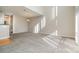 Bright living room featuring high ceilings and carpet flooring at 3649 Warp St, Charlotte, NC 28205