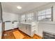 Bright laundry room with white cabinets and wood floors at 419 Williamson St, Fort Mill, SC 29715