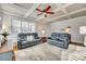 Bright living room with coffered ceiling,reclining sofas, and hardwood floors at 419 Williamson St, Fort Mill, SC 29715