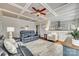 Sunlit living room with coffered ceiling,reclining sofas, and hardwood floors at 419 Williamson St, Fort Mill, SC 29715