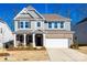 Two story home with gray siding, brick accents, and a two car garage at 469 Shallowford Dr, Rock Hill, SC 29732