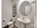 Powder room with pedestal sink, toilet and large vanity mirror at 469 Shallowford Dr, Rock Hill, SC 29732