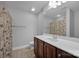 Bathroom with shower/tub combo, vanity with dark brown cabinets, and patterned shower curtain at 4829 Boomerang Way, Charlotte, NC 28269