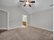 Bright bedroom with ceiling fan, carpet, and access to bathroom at 4829 Boomerang Way, Charlotte, NC 28269