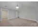 Well-lit bedroom with vaulted ceiling, carpet flooring, and access to a closet at 4829 Boomerang Way, Charlotte, NC 28269