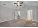 Spacious bedroom with ceiling fan and multiple doors leading to bathroom and hallway at 4829 Boomerang Way, Charlotte, NC 28269