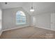 Bright bedroom featuring a vaulted ceiling, carpet flooring, and an arch window at 4829 Boomerang Way, Charlotte, NC 28269