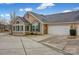 Rear view of home showcasing attached garage and sunroom at 4829 Boomerang Way, Charlotte, NC 28269