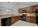 Modern kitchen with black appliances and granite countertops at 4829 Boomerang Way, Charlotte, NC 28269