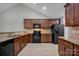 Modern kitchen featuring dark wood cabinets and granite countertops at 4829 Boomerang Way, Charlotte, NC 28269