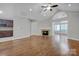 Open concept living room with hardwood floors and fireplace at 4829 Boomerang Way, Charlotte, NC 28269