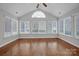 Sunroom with hardwood floors, many windows and access to other rooms at 4829 Boomerang Way, Charlotte, NC 28269