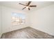 Spacious bedroom with wood-look floors and large window at 509 Tallwood Ct, Charlotte, NC 28216