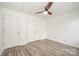 Bedroom with double door closet, hardwood floors, and ceiling fan at 509 Tallwood Ct, Charlotte, NC 28216