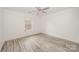 Bright bedroom with wood-look floors and a ceiling fan at 509 Tallwood Ct, Charlotte, NC 28216