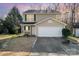 Two-story house with tan siding, green shutters, and a white garage door at 509 Tallwood Ct, Charlotte, NC 28216