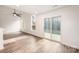 Living area with hardwood floors and sliding glass doors at 509 Tallwood Ct, Charlotte, NC 28216