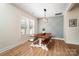 Bright dining room features a farmhouse table with benches and a stylish light fixture at 535 Grampian Rd, Mt Ulla, NC 28125