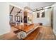 Open concept dining room with a rustic wood table and view into the living room at 535 Grampian Rd, Mt Ulla, NC 28125