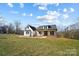 White farmhouse with a wraparound porch, and nicely landscaped yard at 535 Grampian Rd, Mt Ulla, NC 28125