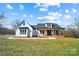 White farmhouse with a wraparound porch, and landscaped yard at 535 Grampian Rd, Mt Ulla, NC 28125