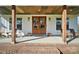 Inviting front porch with wooden rocking chairs and double doors at 535 Grampian Rd, Mt Ulla, NC 28125