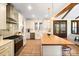 Modern kitchen with white cabinets, butcher block island, and stainless steel appliances at 535 Grampian Rd, Mt Ulla, NC 28125