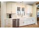 Kitchen with farmhouse sink, white cabinets, and herringbone backsplash at 535 Grampian Rd, Mt Ulla, NC 28125