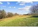 Open field landscape with trees and blue sky at 535 Grampian Rd, Mt Ulla, NC 28125