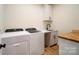 Bright laundry room with washer, dryer, and built-in cabinets at 535 Grampian Rd, Mt Ulla, NC 28125