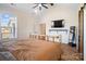 Main bedroom with a rustic log bed frame, large TV, and a walk-in closet at 535 Grampian Rd, Mt Ulla, NC 28125