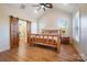 Spacious main bedroom with a log bed frame, barn doors, and an ensuite bathroom at 535 Grampian Rd, Mt Ulla, NC 28125