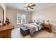 Spacious bedroom with wood furniture and large window at 6049 Bluebird Hill Ln, Weddington, NC 28104