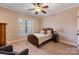 Cozy bedroom with wood bed frame and window seat at 6049 Bluebird Hill Ln, Weddington, NC 28104