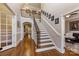 Two-story foyer with hardwood floors and iron railing at 6049 Bluebird Hill Ln, Weddington, NC 28104