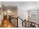 Upstairs hallway with hardwood floors and access to bedrooms at 6049 Bluebird Hill Ln, Weddington, NC 28104