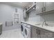 Laundry room with gray cabinets, washer, and dryer at 6049 Bluebird Hill Ln, Weddington, NC 28104