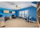 Home office with blue walls, built-in shelving, and workspace at 6049 Bluebird Hill Ln, Weddington, NC 28104