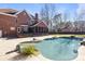 Inviting pool with ample patio space and screened porch at 6049 Bluebird Hill Ln, Weddington, NC 28104