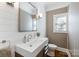 Modern powder room with white sink, toilet, and shiplap walls at 6049 Bluebird Hill Ln, Weddington, NC 28104